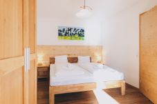 Bedroom in the holiday apartment Haus Altenberger Apartments by we rent. Cozy double bed with bedding.