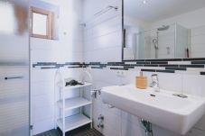 Bathroom in Apartments Haus Altenberger by we rent. Sink, soap, and mirror. Modern bathroom amenities.