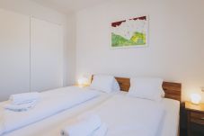 Bedroom in the holiday apartment Haus Altenberger Apartments by we rent. Cozy double bed with bedding.