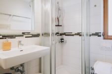 Bathroom in Apartments Haus Altenberger by we rent. Sink, soap, and shower. Modern bathroom amenities.